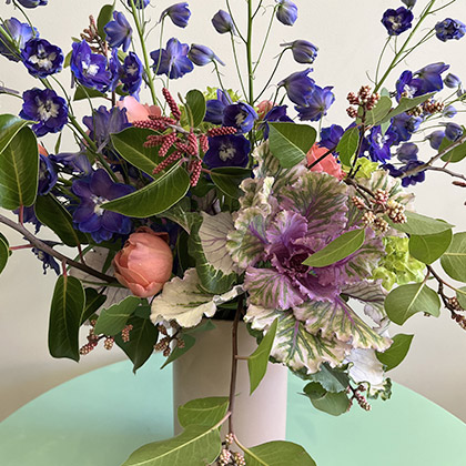 Early spring flower arrangement with ornamental kale, delphinium, sumac, small green hydrangeas and romantic antique roses
