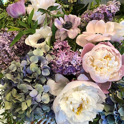 Early liliac from Holland mixed with shades of lavender blush anemones, and muted shades of pale peonies and hydrangeas complete this beautiful Winter flower arrangement.