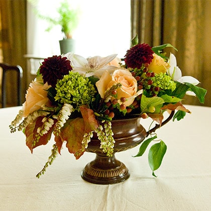 A lovely floral centerpiece graces a table during the event set up.
