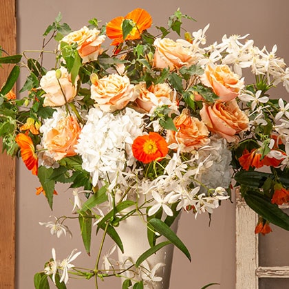 Wild and full of life with white clematis, Icelandic poppies and David Austin roses to make a Winter floral statement.