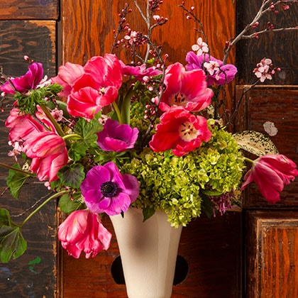 Flowering Plum branches, tulips, anemones and hydrangea complete this February flower arrangement.