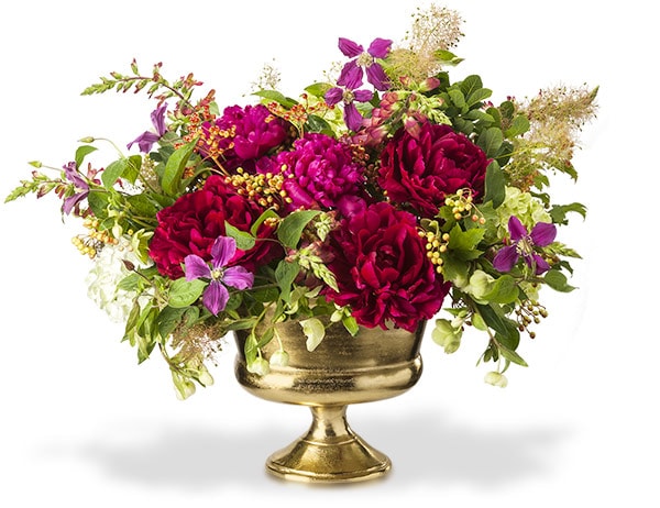 A beautiful centerpiece of deep red peonies, clematis, hydrangea and hellebore in a gold metal urn.