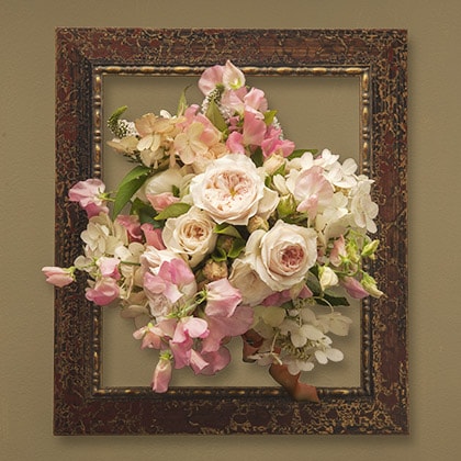 Bridal bouquet with pink sweet peas, blush garden roses, oak leaf hydrangeas, white lysimachia and tea dyed organza ribbon.